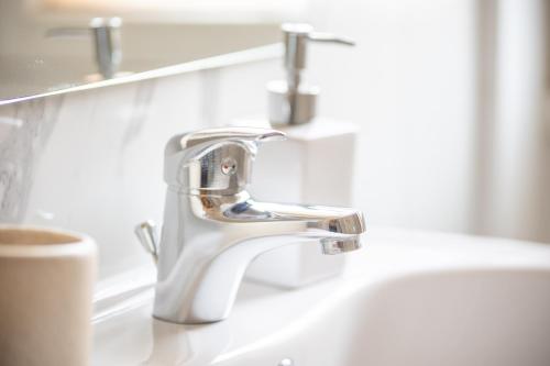 a bathroom sink with a chrome bathroom faucet at Leia Hospitality in Milan