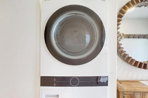 a washing machine in a wall with a mirror at Aquarius in St. George Island