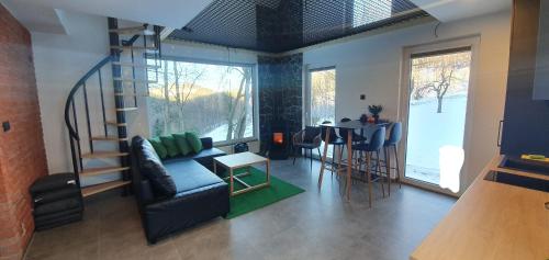 a living room with a couch and a table at OFF Chata na Oślaku, Jacuzzi & Sauna in Jaworzna