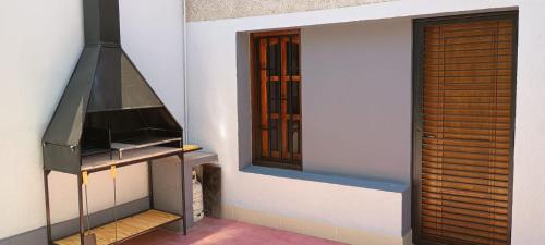 a room with a stove and a window at temporary rental Mendoza in Guaymallen