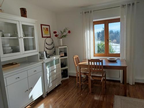a kitchen with a table and chairs and a window at Ferienhaus Familie Zimmermann in Keutschach am See