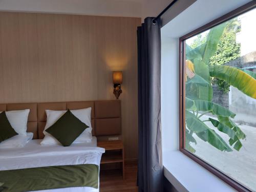 a bedroom with a bed and a window at Comfy Cool Breeze by eMzaz in Dhiffushi