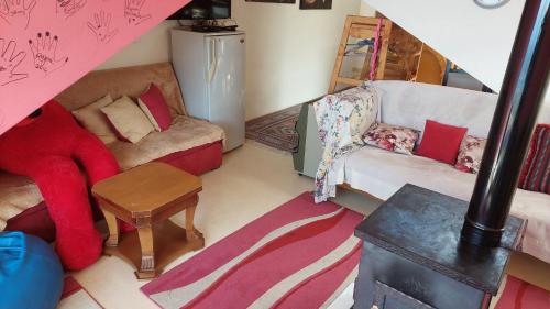 a living room with a couch and a chair at Arcadia Guesthouses - Ghazir, Lebanon in Ed Dkârîne