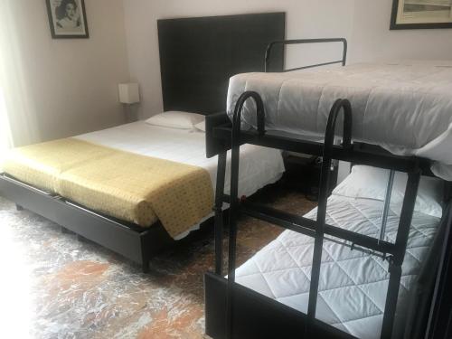 two bunk beds in a room with water on the floor at Boutique Hotel Liberty 1904 in Bologna