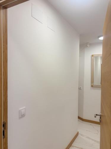 an open door in a room with a white wall at Fuentes de luz in San Sebastián de los Reyes