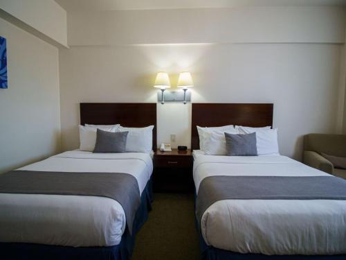 Ένα ή περισσότερα κρεβάτια σε δωμάτιο στο Aron International Hotel