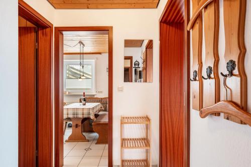 a kitchen with a table and a dining room at Lorenzenhäusle Titisee-Neustadt in Titisee-Neustadt