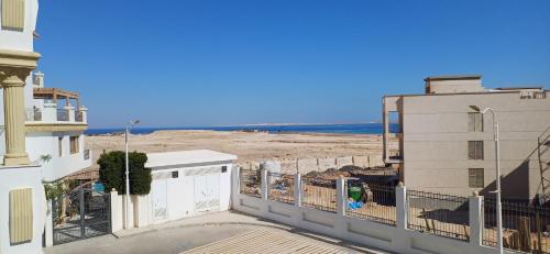 a view of the beach from the balcony of a building at Sharm hills sea view in Sharm El Sheikh