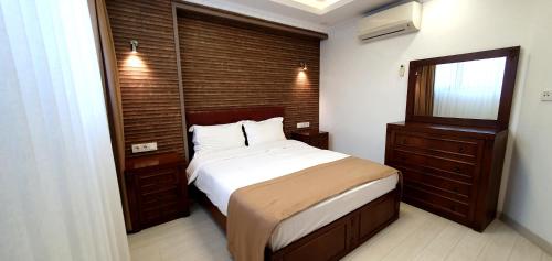 a bedroom with a bed and a dresser and a mirror at Taksim Flat in Istanbul