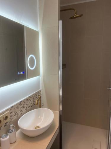 a bathroom with a white sink and a shower at Pension Ottenheide in Schloß Holte-Stukenbrock