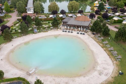 an aerial view of a swimming pool with a resort at Camping La Croix du Vieux Pont in Berny-Rivière