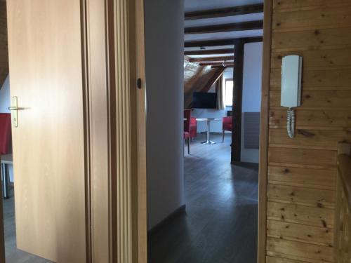 a room with a door and a hallway with a table at Kulisse Apartments in Günzburg