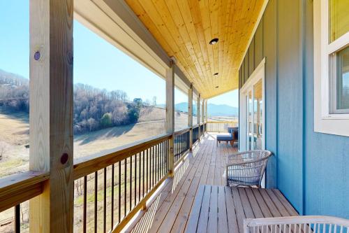 a porch of a house with a view of the ocean at Hillside Escape in Waynesville