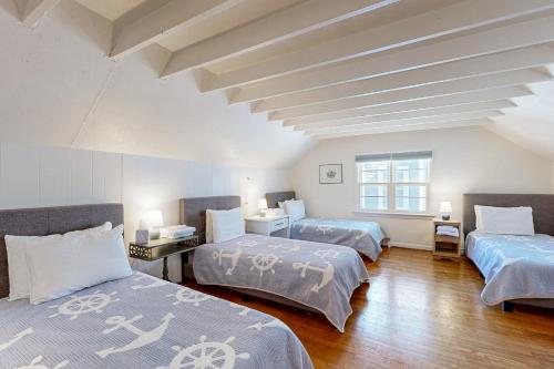 two beds in a room with two windows at Ann Acres --- 21069 Elizabeth Ave. in Rehoboth Beach