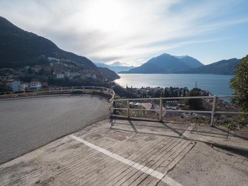 a bench on the side of a road next to a body of water at Lake Dream 1 Lake View of COMO in Bellano