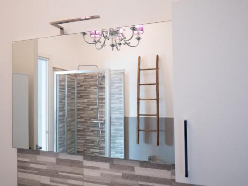 a mirror in a bathroom with a chandelier at Lake Dream 1 Lake View of COMO in Bellano