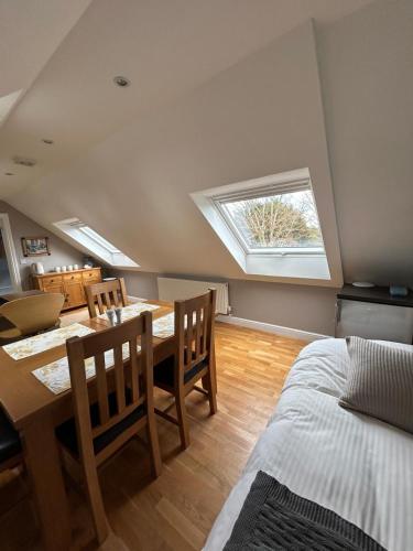 a room with a table and chairs and a window at Magog View in Sawston