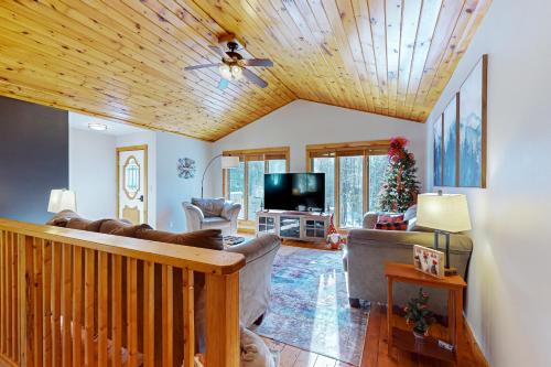 a living room with a wooden ceiling at Big St Germain Hideaway in Sayner