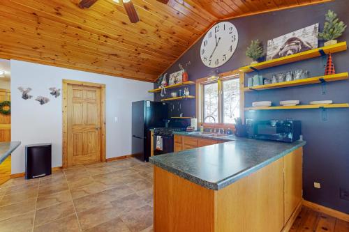 a large kitchen with a large clock on the wall at Big St Germain Hideaway in Sayner