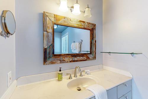 a bathroom with a sink and a mirror at Big St Germain Hideaway in Sayner