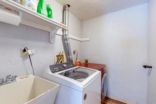 a small laundry room with a washing machine in it at Big St Germain Hideaway in Sayner