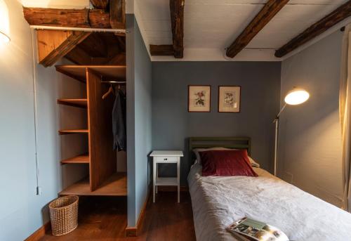 a bedroom with a bed and a book shelf at Foresteria San Rocco Borgoluce in Susegana