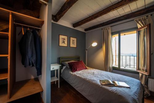 a bedroom with a bed and a window at Foresteria San Rocco Borgoluce in Susegana