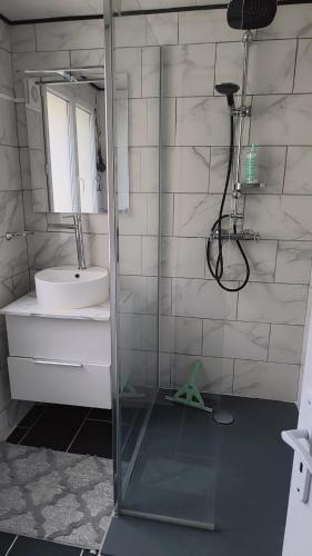 a bathroom with a shower and a sink and a mirror at Calaisis room bed in Calais