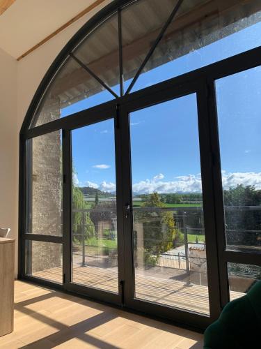a window in a house with a view of the mountains at La Jassine in Mison