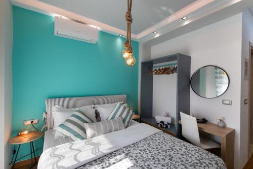 a bedroom with a blue wall and a bed at Lefkas Villas in Lygia