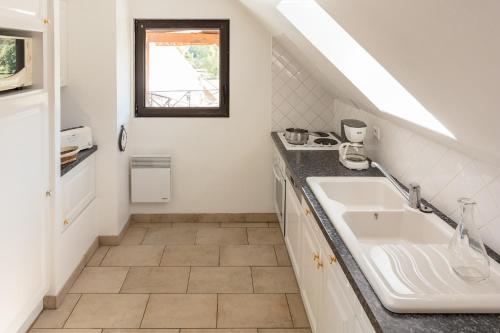 a bathroom with a sink and a window at Camping La Croix du Vieux Pont in Berny-Rivière