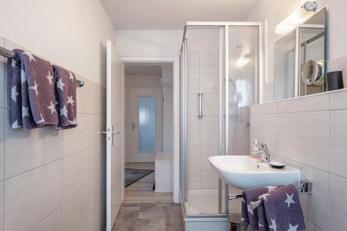a white bathroom with a sink and a shower at Ferienwohnung Dachtler in Hinterzarten