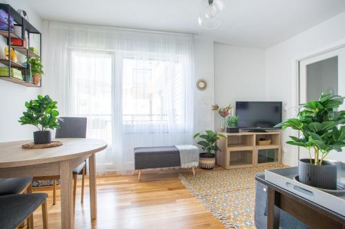 un salon avec une table et une télévision dans l'établissement Apartamento Urdaibai Busturia cerca de la playa, à Busturia