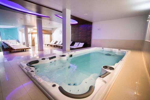 a jacuzzi tub in the middle of a room at Hotel Phoenix in Zagreb