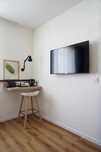 a room with a table and a lamp on a wall at Hotel Convictus Cracovia for business & travellers in Kraków