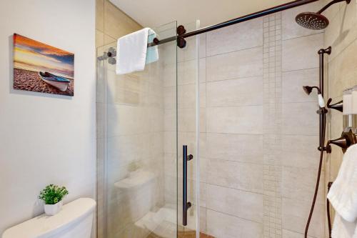 a shower with a glass door in a bathroom at Serenity at Deerhaven #B & #C in Gold Beach