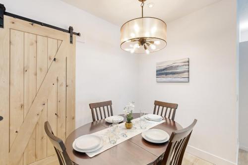a dining room with a table with chairs and a chandelier at Serenity at Deerhaven #B & #C in Gold Beach
