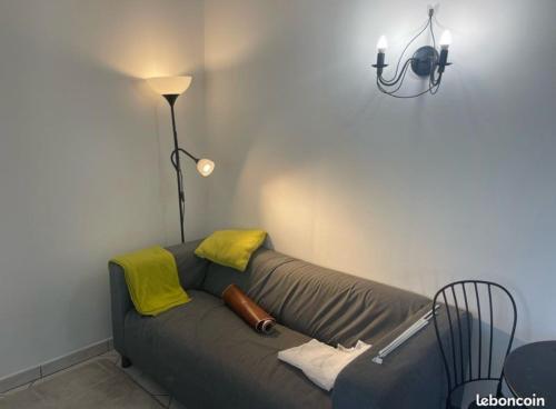 a living room with a couch and a lamp at Close to Paris & Disney & Ofpra in Le Perreux-Sur-Marne