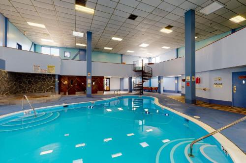 a large swimming pool with blue water in a building at The Pinnacle Inn 3318 in Beech Mountain