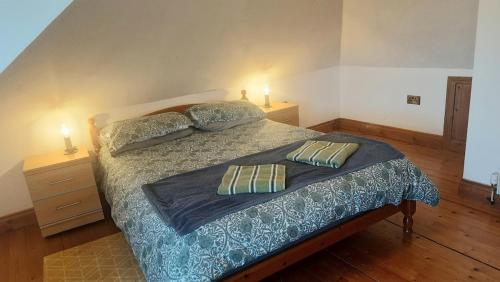 a bedroom with a bed with two pillows on it at Family seaside home, easy access to Edinburgh in Kinghorn