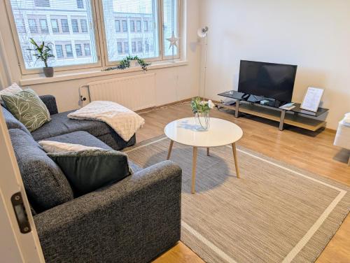 a living room with a couch and a table at 20 - Nice apartment in Kemi City Centre, free parking! in Kemi