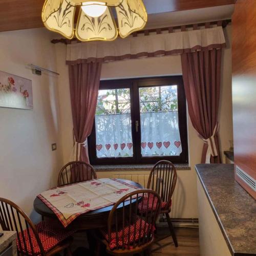 a table and chairs in a kitchen with a window at Holiday home in Lokve, Croatia 47707 in Lokve