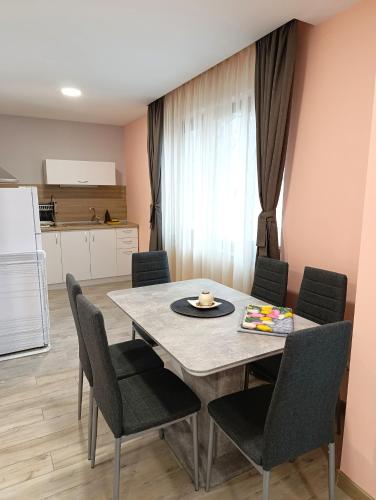 a kitchen and dining room with a table and chairs at Lime house in Kyustendil