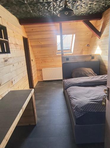 a bedroom with a bed in a wooden room at Haus Feierabend in Plodda