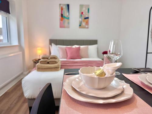 a dining room with a table with a bowl of food at Great Studio 30min to Central London in London
