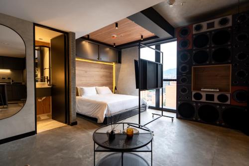a bedroom with a bed and a tv in a room at Indie Universe Creative Hotel in Medellín
