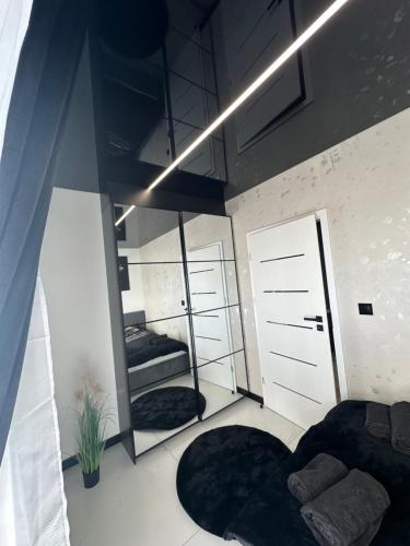 a bedroom with two beds and a mirror at Apart LUXE - Faktura VAT , Parking w garażu podziemnym , Taras in Koszalin