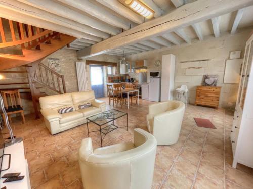 a living room with white furniture and a table at La Saulainière in Pontlevoy