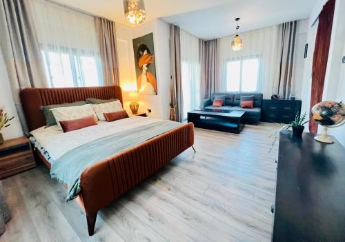 a bedroom with a large bed and a couch at Boutique Townhouse Kyrenia in Kérynia