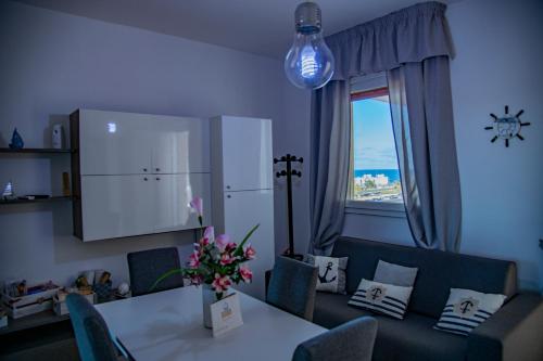 a dining room with a table and a window at Goccia Bianca - Gocce sul Mare in Savelletri di Fasano